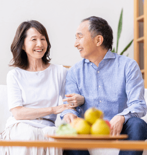 An old couple smiling each other