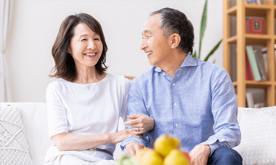 An old couple smiling each other